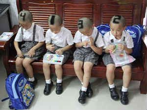 Mother shaves numbers on heads Mother shaves numbers on heads