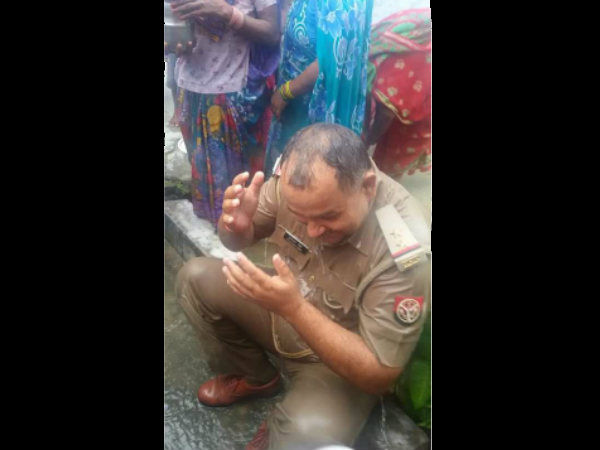 Bizarre tradition: Cop bathed by women for appeasing rain gods! Bizarre tradition: Cop bathed by women for appeasing rain gods!