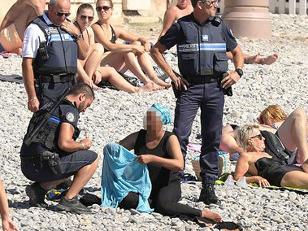 French police make woman remove clothing on Nice beach following burkini ban French police make woman remove clothing on Nice beach following burkini ban
