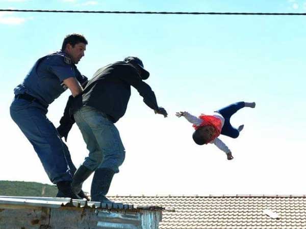 Shock as father throws baby off roof during stand-off with police Shock as father throws baby off roof during stand-off with police