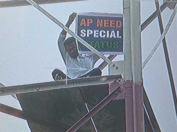 a man holding a banner reading ap needs special status climbs a tower in delhi a man holding a banner reading ap needs special status climbs a tower in delhi