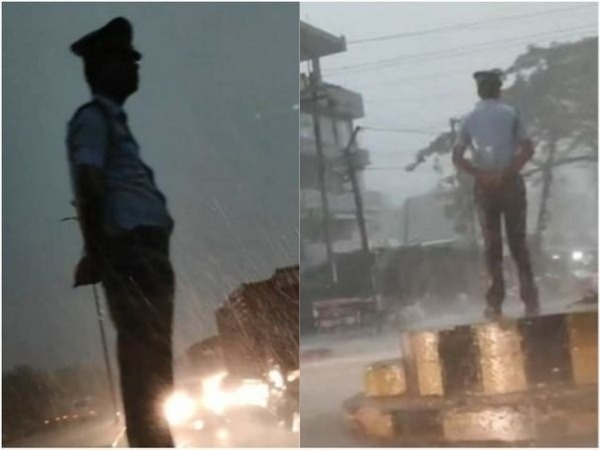 Assam traffic cop carry out duty in heavy rain Assam traffic cop carry out duty in heavy rain
