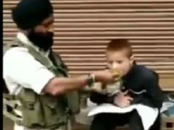 CRPF Soldier feeds his lunch to paralytic child in srinagar CRPF Soldier feeds his lunch to paralytic child in srinagar