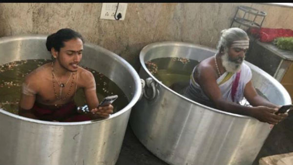 priests performed puja for early monsoon sitting in vessels filled with water. priests performed puja for early monsoon sitting in vessels filled with water.