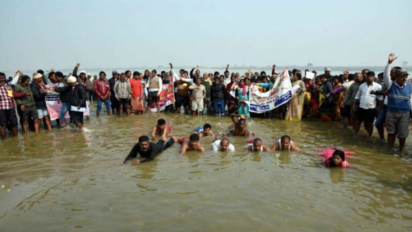 Villagers Protest standing in water for a bridge over river Ganga Villagers Protest standing in water for a bridge over river Ganga