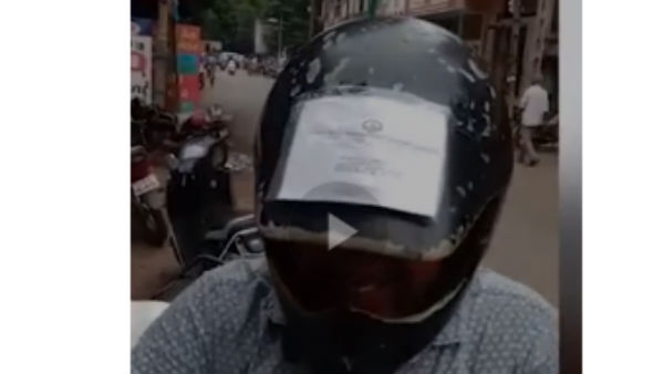 man carries all his vehicle-related documents on the helmet, man carries all his vehicle-related documents on the helmet,