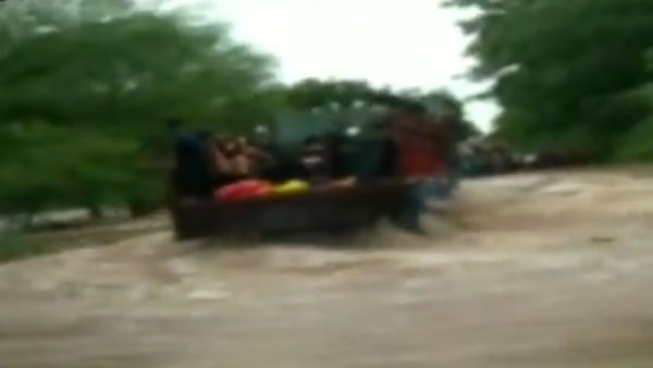 Narrow escape for 20 school children after the truck they were traveling in veered off the flooded road in Dungarpur Narrow escape for 20 school children after the truck they were traveling in veered off the flooded road in Dungarpur
