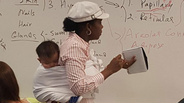 professor holds baby while teaching in the class professor holds baby while teaching in the class