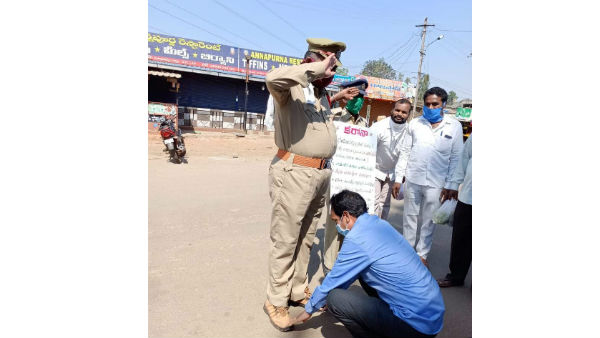 YSRCP MLA Chetti Palguna touches the cops feet who render the service in lockdown duties YSRCP MLA Chetti Palguna touches the cops feet who render the service in lockdown duties