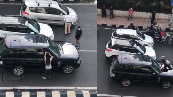 Suspecting husband of having an affair, woman blocks his car on road.. Suspecting husband of having an affair, woman blocks his car on road..