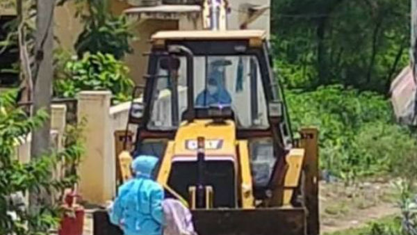 A woman dead body taken to burial ground by jcb in nizamabad district. A woman dead body taken to burial ground by jcb in nizamabad district.