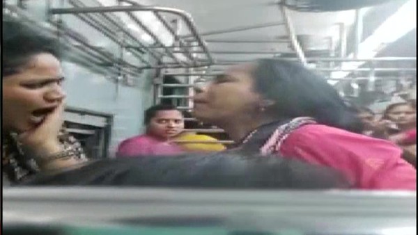 Mumbai: Women passengers hit each other, pull hair over seat on local train. Mumbai: Women passengers hit each other, pull hair over seat on local train.